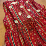 Red floral sleeveless pleated kurta with gota patti flowers paired with straight pants